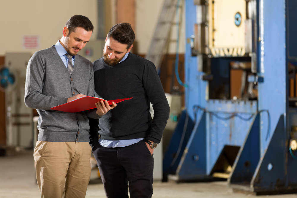 Two,Businessman,Working,In,Factory.